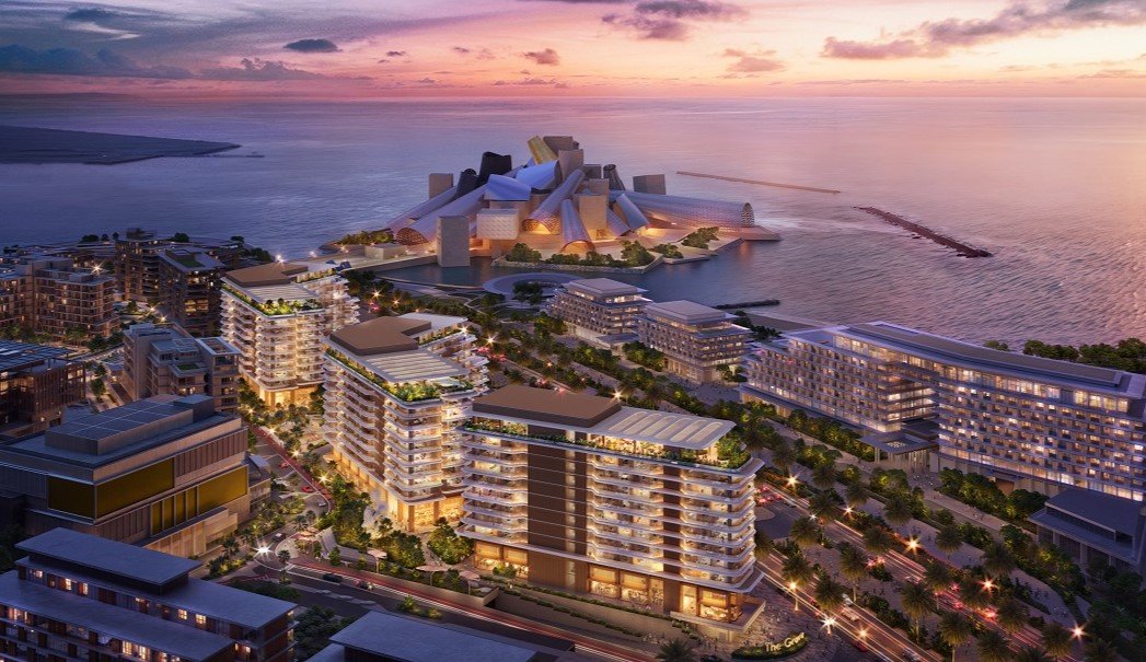 Nighttime view of The Arthouse overlooking Guggenheim Abu Dhabi and the illuminated Abu Dhabi skyline.
